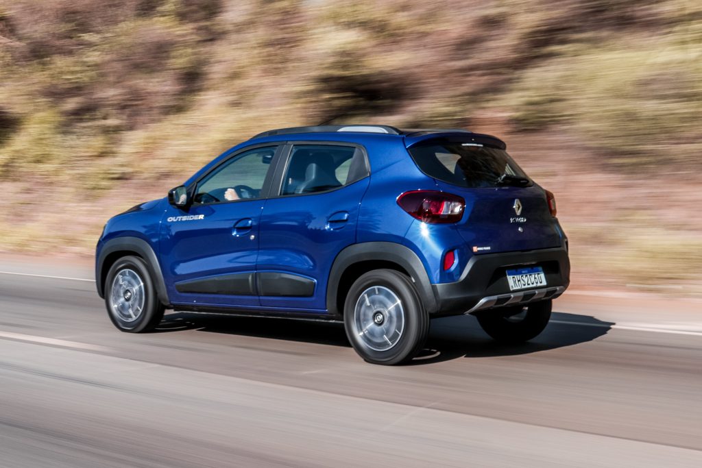 Renault Kwid azul de traseira em movimento; hoje o modelo é o carro mais barato do Brasil.