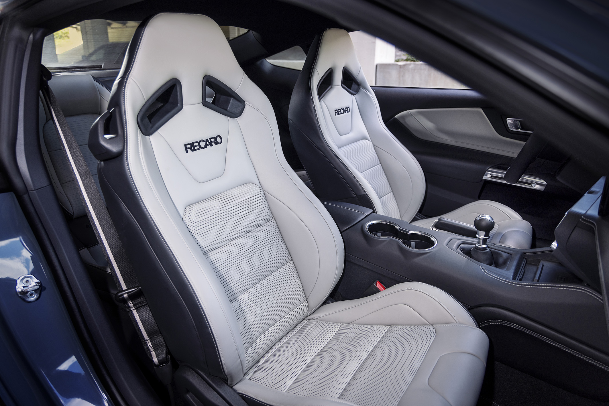 Interior of the new Mustang with white seats with black accents.