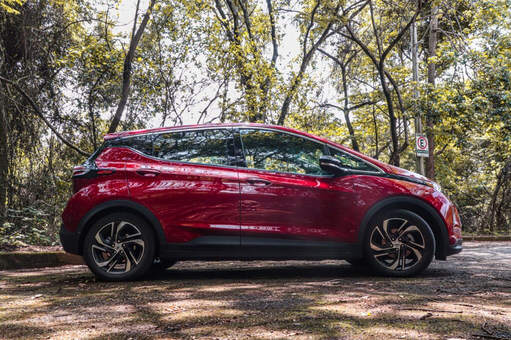 Chevrolet Bolt EV 2023 vermelho de lado estacionado