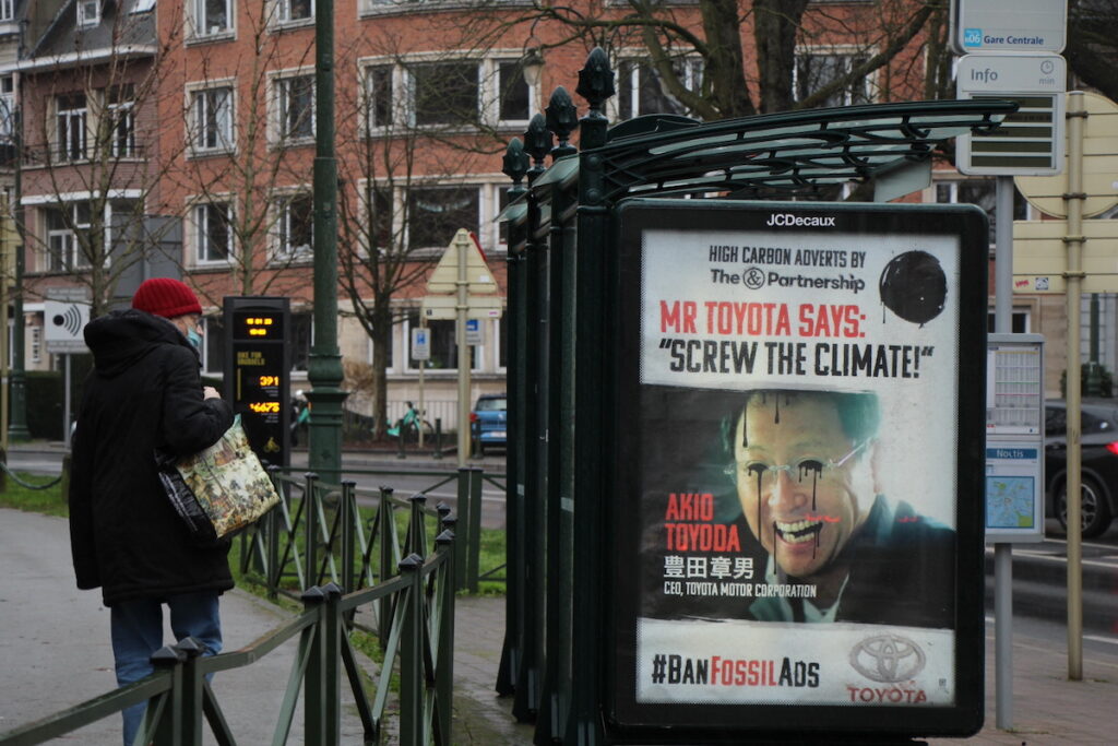 Outdoor subvertido com mensagem de ataque à Toyota. A frase diz "O Sr. Toyota diz: 'dane-se o clima'".