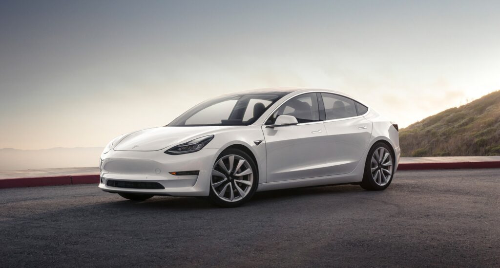 Tesla Model 3 branco visto da diagonal frontal. 