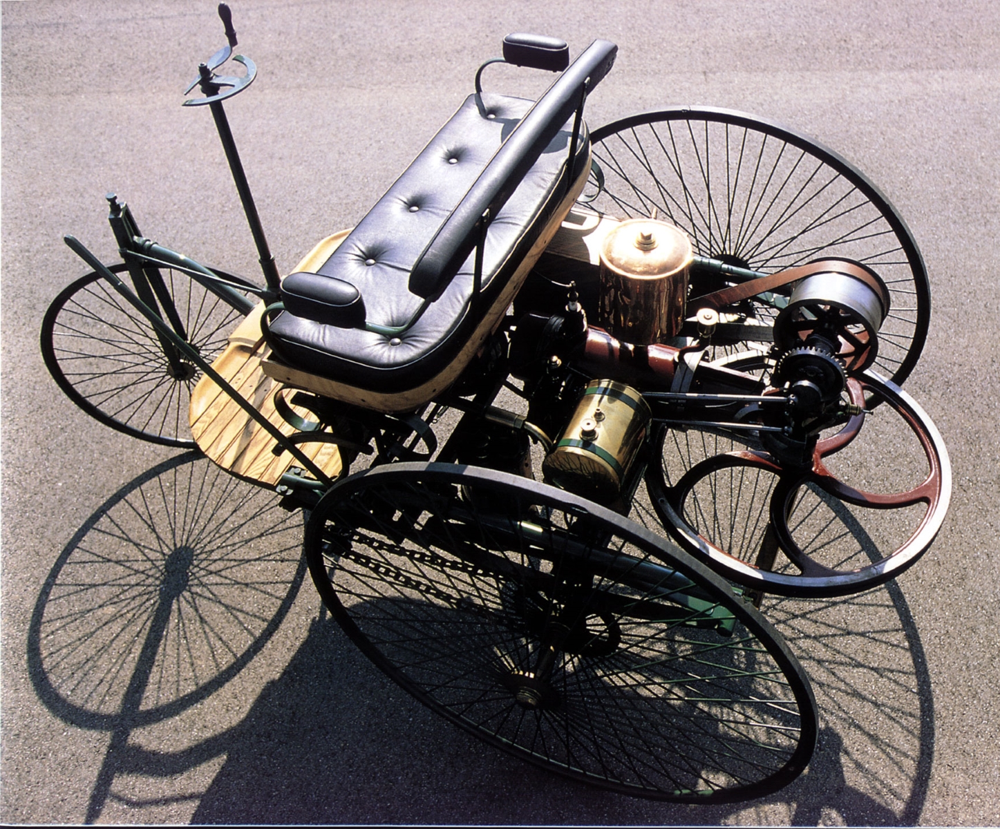 motorwagen triciclo feito por karl benz visto de cima no asfalto